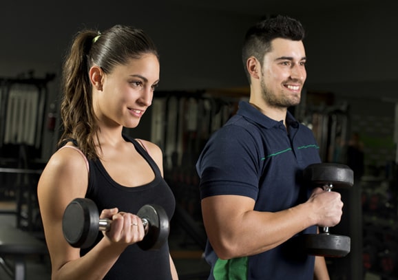 girl & boy exercising with dumbbells
